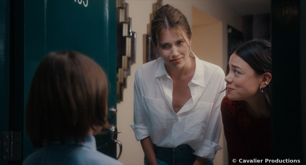 Liz and Julia peering round a doorway